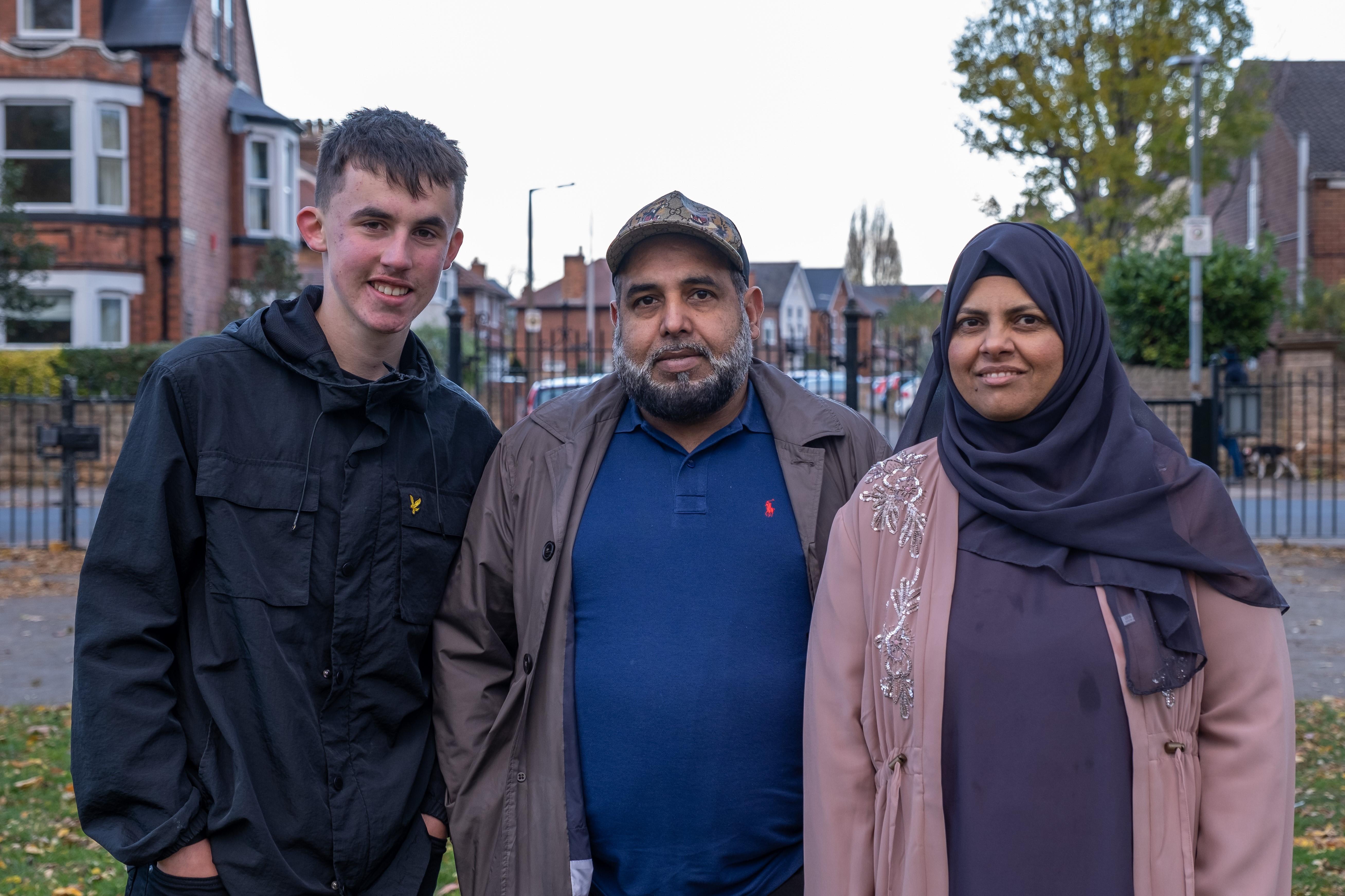 A couple of foster carers with their foster child smiling